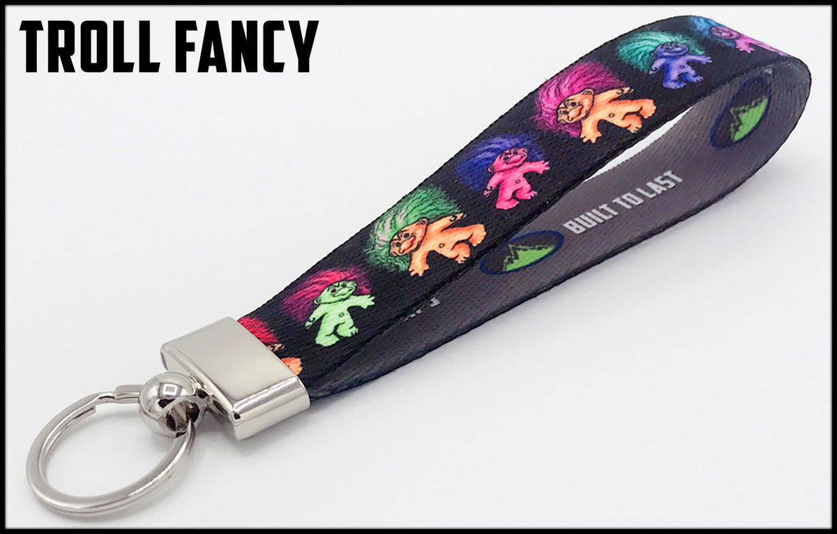 Trolls on black background. 1 inch custom picture quality polyester webbing keyfob. Design by Northwest Straps.
