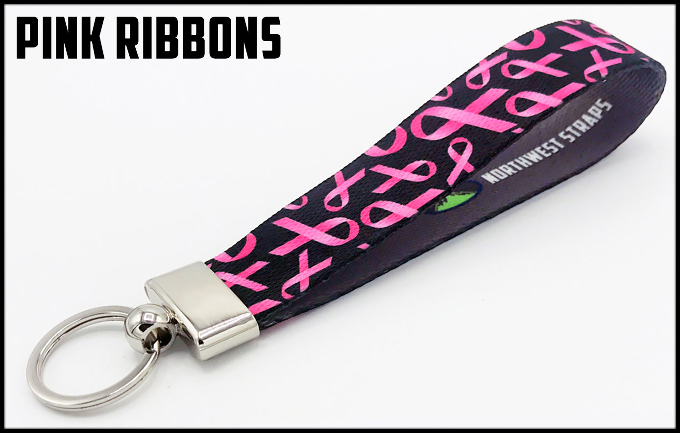 Pink ribbons on black background. 1 inch custom picture quality polyester webbing keyfob. Design by Northwest Straps.